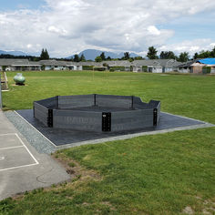 an empty swimming pool in the middle of a park