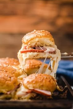 a close up of a sandwich being cut in half on a tray with other pastries