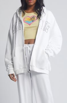 A roomy hoodie features a beachy image and the brand's signature spelled out on the front. 27" length (size M/L) Front zip closure Drawstring hood Split kangaroo pocket 99% rayon, 1% spandex Machine wash, tumble dry Imported White Sporty Hoodie For Leisure, Sporty White Hoodie For Leisure, White Oversized Sweatshirt With Double-lined Hood, White Drawstring Hood Sweatshirt For Leisure, Casual White Hoodie With Drawstring, White Hooded Sweatshirt For Leisure, White Hoodie With Drawstring For Streetwear, White Drawstring Hoodie For Streetwear, White Athleisure Hoodie With Drawstring