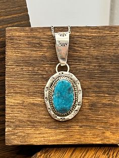 Main Stone:  Candelaria Turquoise Metal:  Sterling Silver Style:  Pendant Pendant Size: 3/4" x 1" Key Features: Turquoise pendant This beautiful turquoise pendant will be an exceptional addition to anyones jewelry collection!!  The stone is complimented by the gorgeous southwestern designed sterling silver and would be a great gift to that special someone, or treat yourself to it! Created in:  Manassa, Colorado Care instructions:   To prolong the life of your jewelry do not submerse in water, ap Artisan Turquoise Oval Pendant Necklace, Artisan Blue Turquoise Necklace Untreated, Southwestern Blue Chrysocolla Jewelry, Handmade Southwestern Turquoise Round Pendant Necklace, Blue Turquoise Necklace With Large Chrysocolla Pendant, Blue Turquoise Chrysocolla Necklace With Large Pendant, Turquoise Necklace With Large Chrysocolla Pendant, Untreated Oval Blue Turquoise Necklace, Blue Rustic Necklace For Gifts