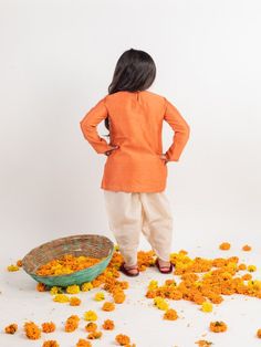 Orange chanderi emnbroidered yoke kurta set with dhoti pants. Color: Orange Fabric: Chanderi Note: The product will be delivered within 2-4 weeks of order placed Wash Care - Dry clean only No returns and Exchange. Measure before ordering to avoid any returns. Measurements: SIZE CHART FOR GIRLS Age CHEST ROUND WAIST ROUND KURTA LENGTH SLEEVE LENGTH BOTTOM LENGTH CHEST ROUND (ANGRAKHA) DRESS LENGTH (angrakha) LEHENGA BLOUSE LENGTH LEHENGA CHEST LEHENGA LENGTH 1-2 YEARS 24 17 17 14 19 20 17 10.5 23 Cotton Dori Work Sets For Puja, Traditional Festive Pant Set With Dori Work, Chanderi Sherwani For Navratri Puja, Navratri Puja Sherwani In Chanderi, Bollywood Pant Set With Dori Work For Eid, Cotton Churidar With Dabka For Puja, Bollywood Style Dori Work Pant Set For Eid, Chanderi Sherwani With Dori Work For Puja, Cotton Dabka Churidar For Puja