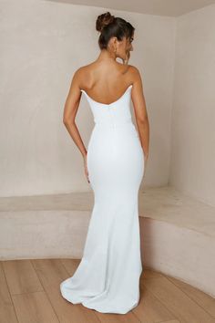 Step into the realm of timeless glamour with the Celine Gown in White. It is a strapless masterpiece designed to captivate hearts. It features a fully structured bodice, peak detailing over the front bust and back which creates a flawless silhouette that will leave onlookers in awe. It has an invisible zipper at the center back which ensures a seamless fit. Wear the Celine Gown to a red-carpet event, a gala or black-tie wedding. Runs true to size If you are in-between sizes, we recommend the siz Wedding Strapless Dress With Pleated Bodice And Straight Neckline, Wedding Strapless Dress With Straight Neckline And Lined Bodice, White Strapless Dress For Gala During Prom Season, Elegant Strapless Dress With Boned Bodice For Debutante Ball, Strapless Dress For Debutante Ball, Strapless Dress With Sweetheart Neckline For Debutante Ball, Strapless Bridesmaid Gown With Pleated Bodice, Wedding Corset Dress With Fitted Bodice And Straight Neckline, Pleated Bodice Strapless Dress For Debutante Ball