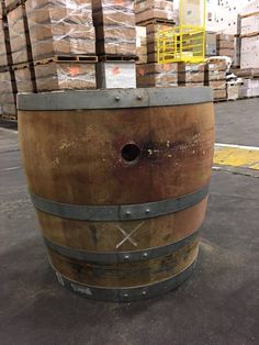 a large wooden barrel sitting in the middle of a warehouse