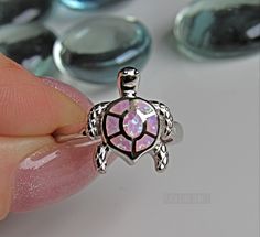 Lab Pink Opal ring - Opal turtle silver ring - Turtle ring - womens silver ring - cute ring - turtle lover Some sizes are sold out. But will be replenished shortly Height of ring is 16.7mm and width is 14.4 Band width 2.4mm and shank is 2.4mm This is a Lab Opal created stone in an inlay setting High Polished, solid 925 sterling silver. Rhodium plated to prevent tarnishing. TARNISH FREE Rhodium plated to avoid tarnishing Nothing but the best from my custom jewelry store. If it doesnt fit, you hav Sterling Silver Turtle-shaped Rings, Silver Turtle Jewelry, Pink Opal Ring, Turtle Ring, Star Labs, Cute Ring, Vero Beach Fl, Ring Opal, Vero Beach