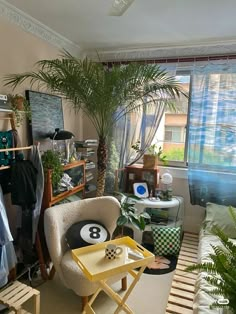 a living room filled with furniture and plants