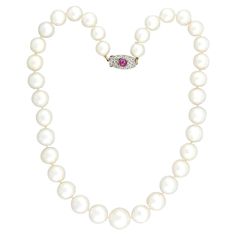 A classically beautiful and very unique South Sea Pearl convertible necklace with a gorgeous diamond and ruby clasp from the Edwardian (ca1910s) era ! This fabulous piece is comprised of a single strand of 35 substantially sized pearls which are hand-knotted on ivory-colored thread and exhibit a silvery white color and exceptional luster. The strand features a platinum-topped 18k yellow gold clasp that displays a fantastic radiant motif with intricate milgrain detail, encrusted with 20 bead-set Rose Cut diamonds and one bezel-set ruby cabochon at the center. This feminine, elegant necklace is so versatile and would look gorgeous in any pearl lover's collection! Measurements: The necklace measures approximately 18.5" in total length. The pearls range in size with 10mm being the smallest and Pearl Necklace With Diamond, South Sea Pearl Necklace, Convertible Necklace, Pearl Clasp, Necklace With Diamond, Necklace Clasp, Pearl And Diamond Necklace, Necklace Clasps, Ruby Necklace