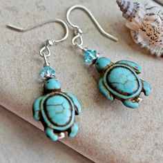 We love sea turtles! Handmade earrings featuring blue dyed stone turtle beads, crystals, hanging from silver ear wires. Each earring is approximately 1 1/2 inches long measured from the top of the ear wire, and are approximately 1/2 inch wide. Thank you for visiting CoconutGroveGalleria.etsy.com. Don't forget to visit and like our Facebook page for specials and give-aways at https://www.facebook.com/coconutgrovejewelry. Have a blessed day! ~Donna :) Blue Sea Turtle, Crystals Hanging, Pearl Cream, Sea Turtles, Stone Crystal, Ear Wire, Sea Turtle, Blue Sea, Handmade Earrings