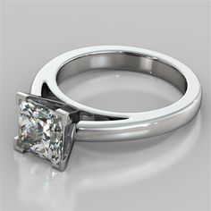 a white gold ring with a princess cut diamond