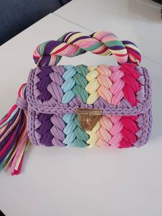 a multicolored handbag sitting on top of a table