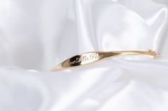 We call her perfect because once we perfected the sample for this bangle, we didn't take her off for 2 years. Fancy, but not too fancy. Just the right shape. Just the right width. The one thing you'll always wear. Solid 14k gold bangle with your name, text or bespoke design Engravable on front and inside Hand engraved to order The Perfect Bangle Sizing Small: 6.3in circumference; 52.10mm x 50.25mm diameter Medium: 6.8in circumference; 56.00mm x 54.00mm diameter Large: 7.2in circumference; 60.00m Luxury Engraved Cuff Bracelet For Anniversary, Elegant Engraved Cuff Bracelet For Formal Occasions, Elegant Engraved Cuff Bracelet For Formal, Elegant White Gold Name Bracelet With Engraving Option, 14k Stamped Gold Bracelet For Wedding, Elegant Adjustable Engraved Bangle, Heirloom Style Bracelets With Polished Finish For Wedding, Elegant Adjustable 14k Stamped Bracelets, Elegant Engraved Adjustable Bangle