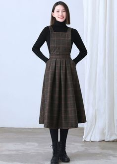 "★★FEATURES * Wool skirt * Polyester lining * Sleeveless * Two side seam pockets * Right hidden zipper closure * Adjustable strap * High waistband * Fit and flare * Perfect for winter, autumn, spring * Dry clean Fabric swatch https://etsy.me/3dIQDkz ★★ The model is 170 cm (5′ 7″) tall with a 80 cm (31.5\") bust, 66 cm (26\") waist. She is wearing the plaid wool dress in size XS. ★★ Bespoke Order Service If you Request other color Request the length Your height is not between 155 cm- 172 cm Your Brown Workwear Dress With Pockets, Winter Wool Tweed Dress Knee-length, Knee-length Wool Tweed Dress For Winter, Winter Midi Dress With Pockets, Winter Wool Tweed Knee-length Dress, Fitted Knee-length Pinafore Dress For Fall, Knee-length Fitted Pinafore Dress For Fall, Fitted Fall Pinafore Dress With Pockets, Fall A-line Dresses With Pockets