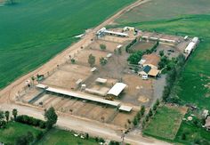 an aerial view of a farm with many buildings