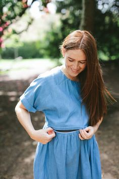 A denim look nursing dress designed for breastfeeding and maternity. A smock length dress with rolled short sleeves  and a casual fit. At Ruma Breastfeeding Wear we design dresses for nursing and maternity that match your pre baby style. Dress for breastfeeding and maternity with a unique two way, hidden zip that can be opened from either side allowing you to nurse your baby comfortably. We've added a quick video to show you how the zip works. This dress is a midi length with a tiered skirt and Relaxed Fit Denim Dress With Short Sleeves, Summer Maternity Dress With Short Sleeves, Modest Short Sleeve Maternity Dress For Summer, Summer Maternity Dress Nursing Friendly, Summer Cotton Maternity Dress Nursing Friendly, Summer Maternity Dress With Nursing Friendly Short Sleeves, Nursing Friendly Short Sleeve Maternity Dress, Blue Nursing-friendly Maternity Dress With Short Sleeves, Blue Short Sleeve Nursing-friendly Maternity Dress