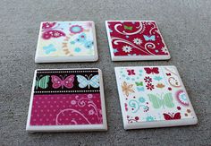 four coasters with different designs on them sitting on the floor next to each other