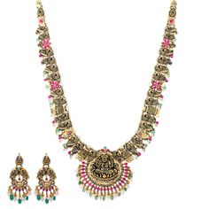 Virani Jewelers' 22k antique gold and gemstone temple jewelry set, a true masterpiece of Indian jewelry. Crafted with intricate precision, this gold necklace and matching earring set exudes cultural elegance. The rustic charm of 22k antique gold seamlessly blends with captivating gemstones, creating a treasure that transcends generations. The detailed depiction of the Goddess Laxmi deity adds divine charm to the set, making it a symbol of spirituality and tradition. Elevate your style with this Luxury Dual-tone Temple Jewelry Necklace, Ceremonial Multicolor Temple Jewelry Choker, Ceremonial 22k Gold Gemstone Temple Necklace, 22k Gold Dual-tone Temple Jewelry, 22k Gold Multi-stone Temple Necklace, Gold Temple Jewellery, Temple Jewellery, Pearl Gemstone, Antique Finish