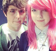 two people with pink hair posing for the camera