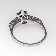 This gorgeous sapphire engagement ring features a 1.56 carat no heat sapphire with Nigeria origin that we sourced and set in an 18k white gold diamond mounting. The top of the shoulders are each accented with a row of three (3), bead set, round single cut diamonds. The ring measures 8.7mm at the top, rises 6.8mm above the finger, tapering to 1.7mm wide and 1.2mm thick at the base of the shank. The ring is currently a size 6.75 and we offer complimentary resizing to fit. Marquise Cut Sapphire Diamond Ring With Center Stone, Emerald Cut Sapphire Ring With Center Stone For Proposal, Luxury Sapphire Ring With Marquise Cut, Sapphire Ring With Brilliant Cut For Proposal, Fine Jewelry Sapphire Ring With Diamond Cut For Proposal, Luxury Round Cut Sapphire Proposal Ring, Sapphire Marquise Cut Brilliant Ring, Brilliant Cut Sapphire Ring For Proposal, Marquise Cut Brilliant Sapphire Ring