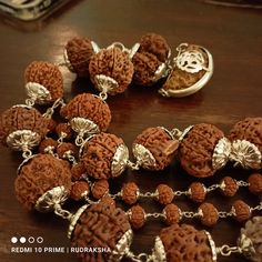 "Introducing the Siddha Mala, a powerful healing Rudraksha mala that can help you achieve success and prosperity in all areas of life. This divine mala is composed of various Rudraksha beads, each with its unique benefits. सर्वेषामपि वक्त्रणां धारणे यो समो भवेत् तस्मात्सर्व प्रयत्नेन रुद्राक्ष पुत्र धारय - पद्मपुराणे \"One who wears all mukhi Rudraksha becomes equal to me (Shiva). So dear Son, one should try by all means to wear all mukhi Rudraksha.\" -Padma Puran भक्तिश्रद्धायुतश्चैव सर्वकामार् Traditional Mala With Gemstone Beads For Healing, Handmade Spiritual Mala For Puja, Spiritual Gemstone Beads Mala For Puja, Spiritual Gemstone Mala For Puja, Silver Spiritual Mala For Puja, Hand-strung Spiritual Mala For Puja, Spiritual Necklaces For Navratri, Handmade Mala For Diwali Meditation, Handmade Mala For Meditation And Diwali