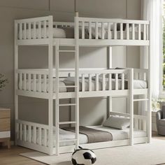 a white bunk bed sitting in a bedroom next to a soccer ball on the floor