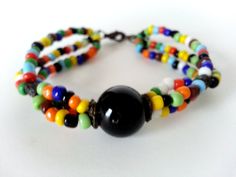 Boho Tibal Multi Colored Three Strand Beaded Large Black Center Bead Bracelet. Love This Bracelet! Large center Black glass Bead!  Measure's  7in L  Perfect Condition!   Sorry No returns. Insurance OR Special shipping request CAN BE ACCOMMODATED please ask before order :) Black Bangle With Colorful Beads, Black Bangle Jewelry With Colorful Beads, Black Bohemian Beaded Bracelet With Colorful Beads, Handmade Black Bead Bangle, Festival Black Bracelets With Large Beads, Handmade Black Bangle Beads, Black Beaded Bohemian Bracelets, Black Round Bead Bracelets For Festival, Black Bohemian Bracelets With Large Beads