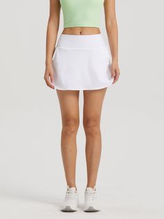 Why We Love It: Experience the perfect blend of style and functionality with the Bella A-line Tennis Skirt. This versatile piece is designed to elevate your performance on the court while keeping you looking chic. Fit and Features: A-line silhouette for a flattering and feminine fit. Built-in shorts provide comfort and coverage. High-waist design for added support and a sleek look. Lightweight and breathable fabric ensures maximum comfort during intense matches. Moisture-wicking technology keeps Chic Mini Skort For Tennis, Spring Tennis Mini Skirt In Solid Color, Fitted A-line Tennis Skirt For Spring, White Pleated Swim Skirt, White 4-way Stretch Skort For Spring, Spring White 4-way Stretch Skort, Lined Mini Skirt For Tennis, Solid Mini Skirt With Lining For Tennis, Solid Color Tennis Mini Skirt With Lining