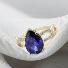 A Sapphire ring ring rich with presence and diamonds. Flaunting a beautiful pear cut Sapphire corundum prong set in your choice of solid gold. Handmade by an inspired jewelry artist team with decades of experience in the craft of jewelry making. Each gemstone, each diamond is carefully picked. Using only the finest raw materials and the highest industry standard in manufacturing, design and finish. A beautiful vintage inspired piece handmade just for you. Set with a 12x8 pear cut blue sapphire c Elegant Pear-shaped Yellow Gold Birthstone Ring, Elegant Gold Ring With Lab-created Sapphire, Yellow Gold Pear-shaped Ring With Accent Stones, Teardrop Diamond Promise Ring, Pear-shaped Yellow Gold Rings With Accent Stones, Elegant Pear Shaped Gemstone Rings, Pear Shaped Yellow Gold Rings With Accent Stones, Teardrop Sapphire Ring Fine Jewelry Gift, Fine Jewelry Pear-shaped Sapphire