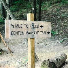 a wooden sign points to the trail where miles to falls and benton mackey trail are located