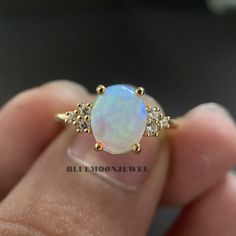 𝐌𝐚𝐢𝐧 𝐒𝐭𝐨𝐧𝐞 𝐃𝐞𝐭𝐚𝐢𝐥𝐬 *Type: Opal *Cut: Oval *Colour: FG *Clarity: VVS1 *Weight: 1.80 Ct (approx) 𝐒𝐢𝐝𝐞 𝐒𝐭𝐨𝐧𝐞 𝐃𝐞𝐭𝐚𝐢𝐥𝐬 *Type: Cubic Zirconia *Shape: Round *Colour: FG *Clarity: VVS1 *Weight: 0.20 Ct (approx) 𝐑𝐢𝐧𝐠 𝐃𝐞𝐭𝐚𝐢𝐥𝐬 *Metal Purity: Solid Gold (10k / 14k / 18k), 925 Sterling Silver *Metal Tone: White / Rose / Yellow *Stamp / Hallmarked: Yes Customization *Diamond: Natural Diamond / Moissanite / CVD -Lab Grown / Cubic Zirconia 𝐑𝐮𝐬𝐡 𝐎𝐫𝐝𝐞𝐫 *Our stan Pearl And Opal Engagement Ring, Anniversary Opal Ring Stamped 14k In Oval Shape, Oval Opal Ring Stamped 14k For Anniversary, 14k Gold Moonstone Ring With Accent Stones For Anniversary, Stamped 14k Oval Opal Wedding Ring, Gold Opal Jewelry With Prong Setting, Dainty Oval Opal Ring For Anniversary, Gold Opal Ring With Accent Stones In 14k Gold, 14k Gold Opal Ring With Accent Stones