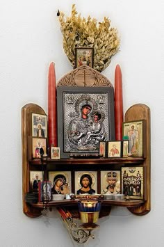 a shelf with pictures and candles on it