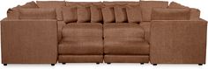 a large brown couch with lots of pillows on it's back and side ends