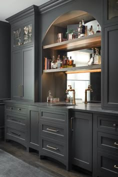 a kitchen with gray cabinets and gold pulls on the cupboards is pictured in this image