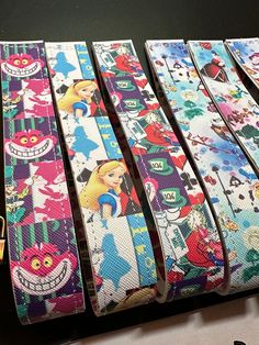 four different colored belts with cartoon characters on them