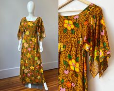 This authentic 1960s Tahitian made dress will bring the tropics to wherever you wear it!  This vintage 60s maxi dress features beautiful flutter sleeves and a fun retro tropical hibiscus print made of mocha and caramel browns, orange, yellow, pink, lime green, and grass green.  The bust and body of the dress are lined with a second layer of the printed fabric while the sleeves flow freely unlined a touch more sheer.  A white zipper in the back of the dress makes this a fitted empire waist column style dress with an illusion of being a slim caftan. It was made in Papeete, the capital of the island of Tahiti in French Polynesia, by Designer "Marie Ah You Couture" and is made of a lightweight cotton gauze.  Tag: Marie Ah You Couture Papeete_Tahiti Material: Thin Woven Cotton  Size: US size S/ Retro Tropical Print Dress For Vacation, Retro Tropical Print Vacation Dress, Vintage Tropical Print Dresses For Spring, Vintage Dresses With Tropical Print For Spring, Vintage Tropical Print Beach Dress, Vintage Beach Dress With Tropical Print, Vintage Tropical Print Dresses For Vacation, Vintage Tropical Print Dress For Vacation, Vintage Dress With Tropical Print For The Beach