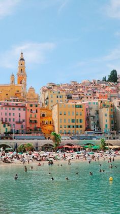 the beach is crowded with people and buildings