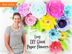 a woman standing in front of a wall made out of paper flowers with the words easy diy giant paper flowers