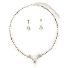 This jewelry set is stunning! It is encrusted with clear, sparkling rhinestones along a silver plate. The necklace measures approximately 15" long. The matching Earrings measure 1.0" long. It is perfect for weddings, proms, formals, parties, pageants, and more. It coordinates with any color or style wedding dress or formal ensemble. Silver Crystal Jewelry Sets With Diamond Accents, Silver Jewelry Sets With Diamond Accents, Silver Jewelry Sets With Diamond Accents And Crystal, Silver Metal Jewelry Sets With Bling, Silver Costume Jewelry Sets With Rhinestones, Silver Costume Jewelry Sets With Bling, Silver Rhinestone Costume Jewelry Sets, Silver Bling Costume Jewelry Sets, Silver Jewelry Sets With Sparkling Stones