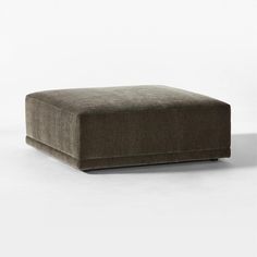 a square footstool made out of fabric