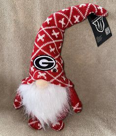 a red and white stuffed toy with a green bay packers logo on it