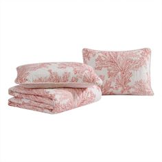 the pink and white bedding is set with two pillows, one has a pillow case