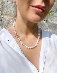 This timeless pearl necklace is composed of 8 mm non-nucleated freshwater pearls with near round shape and amazing lustre. The surface is smooth and almost perfect - everything what you are looked in high quality cultured pearls. Stylish gold vermeil toggle clasp adds a modern twist to this classic necklace.  MATERIAL Freshwater pearls, gold vermeil SPECIFICATIONS  Length 47 cm (18.5 inches) 1 strand, hand-knotted Handmade in Spain Pearls measure 8 mm  Toggle clasp Necklace comes in a gift box W Pearl Necklace With Round Beads And Pearl Charm, Pearl Chain Bridal Necklace, Bridal Round Pearl Necklace With Pearl Chain, Round Pearl Chain Bridal Necklace, Baroque Pearl Necklace With Pearl Charm, Pearl White Bridal Necklace With Pearl Chain, Pearl White Round Bridal Necklace With Pearl Chain, Akoya Pearl Necklace With Round Beads And Pearl Charm, Bridal Round Pearl Necklace With Pearl Charm