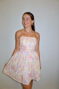 Our 'Isabella' mini dress features a A-line silhouette, strapless neckline, includes cinched belted bow front waist, and allover pink floral detailing. Model is wearing a small. Fits true to size! Size Recommendations 0-4:S, 6:M, 8-10:L All Love <3 Fit And Flare Hoco Dress, Floral Hoco Dress, Pastel Mini Dress, Formal Short Dress, Dresses For Dances, Pink Short Dress, Senior Banquet, Cinched Waist Dress, Nyc Outfits