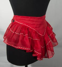 a mannequin wearing a red skirt with white stitching on the bottom and sides