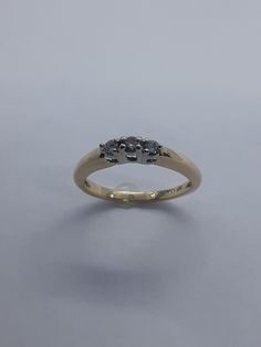 This handmade, beatiful 3 stone ring has been expertly crafted in warm 10k yellow gold and authentic white diamonds. This gorgeous ring will make a great any special occasion/birthday gift. All of my jewelry is handmade from scratch, one item at a time as I like to make sure I am producing a high quality piece. A tracking shipping number will be provided to you once the ring has been shipped. Diamonds measurements: 3 Diamonds 2.5 mm 0.06 each  Diamond total weight : 0.18 cts Ring size : 5 1/2 Ri Gold Three Stone Sapphire Promise Ring, Yellow Gold Diamond Three Stone Birthstone Ring, Gold Three Stone Birthstone Ring For Promise, Gold Three Stone Round Cut Birthstone Ring, Gold Sapphire Ring With Three Diamonds, Gold Birthstone Three Stone Ring For Promise, Gold Three-stone Sapphire Promise Ring, Yellow Gold Three Stone Birthstone Promise Ring, Gold Three Stone Diamond Ring With Round Band