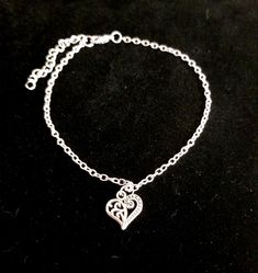 New Handmade Scroll Heart Anklet ~ Stainless steel anklet chain and charm will not tarnish ~ Scroll heart charm ~ Available in several lengths ~ Includes a 2 inch extender ~ Hypoallergenic, Nickle free ~ Ships within 24 hours of purchase Monday-Saturday Gift Packaging & Messages: Your item will be lovingly packaged and labeled as a handmade item.  Item's that ship with gift boxes are stated in the description. Handwritten gift notes available, just include a gift message with your order. Gift packaging also available for purchase at checkout for jewelry item.  Shipping:  * USPS First Class: 3-5 business days * USPS Priority: 2-3 business days *I ship within 24 hours of purchase. Please note that transit time estimates are based on the shipping method you select and are subject to change du Silver Anklet With Lobster Clasp For Gift, Adjustable Heart Metal Anklets, Heart-shaped Metal Anklets For Gift, Heart-shaped Metal Anklets As Gift, Adjustable Heart-shaped Metal Anklet, Elegant Adjustable Anklets With Heart Charm, Adjustable Silver Heart Anklets, Silver Adjustable Heart-shaped Anklets, Dainty Adjustable Anklets For Valentine's Day