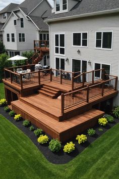 a wooden deck in front of a white house