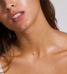 The prettiest Dainty Cross Choker, this 14k Solid Gold Cross Necklace is a special gift to yourself and others, a dainty cross surely to be a beautiful accent piece to any occasion!  This item ships within 1 business day. Model is wearing 15 inches in 14k solid gold. You can choose the center or the sideways design.  We beautifully package every item in a jewelry gift box. * All orders are hand crafted with care from our happy studio in sunny Miami, FL  * All items are ethically sourced by me for durability & perfect finishes * It's not only meant to look beautiful... it's meant to be meaningful * This item is a custom made item and is non-refundable  MIX & MATCH:  For cross hanging earrings click here: https://www.etsy.com/listing/770133263/cross-huggie-hoops-cross-earrings-cross?ga_searc Gold Cross Necklace For Women, Cross Necklace Gold, Cross Necklace For Women, Cross Choker Necklace, Tiny Cross Necklace, Dainty Cross Necklace, Dainty Choker Necklace, Cross Necklace Sideways, Cross Choker