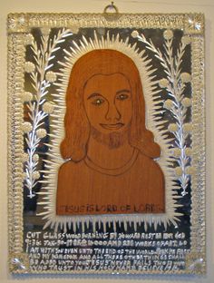 a wooden plaque with the likeness of jesus christe de lore on it's side