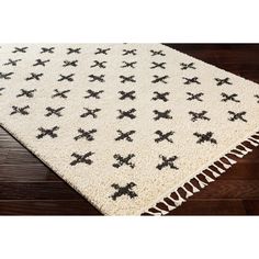 a white rug with black crosses on it