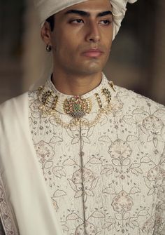 Embrace classic elegance in this ivory and beige raw silk sherwani, adorned with tonal resham embroidery and highlighted with dabka, beads, and crystals. Accompanied by a cotton silk kurta and churidar, it comes with a worked belt and stole. Ivory Sherwani, Dabka Embroidery, Raw Silk Kurta, Shaadi Outfits, Thread Beads, Modern Groom, Resham Embroidery, Traditional Outfit, Silk Kurta