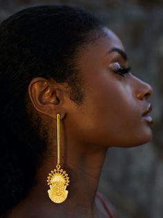 Toronto-based Symbols of Authority specializes in everyday statement jewelry. Inspired by the 16th-century Bini Queen Idia, renowned for her bravery, the Adunni x Idia Bar Earrings boast a shoulder-sweeping bar design. They are handmade from micron-plated brass and etched with the iconic Iyoba ivory mask. Make them the focal point by keeping your other jewelry pieces simple.- Butterfly fastening- Brass, micron-plated gold- Handcrafted by expert artisans using ethically and sustainably sourced materials- Made in Jaipur, India, ships from Canada Ghanaian Gold Jewelry, African Jewelry Gold, Yellow Gold Spiritual Earrings, Temple Jewelry Style Drop Plug Earrings, Ceremonial Drop Earrings, Spiritual Yellow Gold Brass Earrings, Hand Forged Gold Earrings, Black Women Gold Jewelry, Gold Fusion Long Drop Earrings